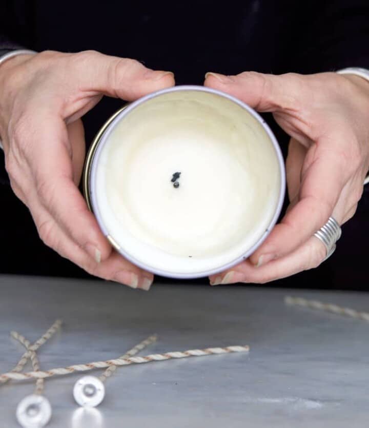 Reusing the old wax from a scented luxury candle to make a new candle.