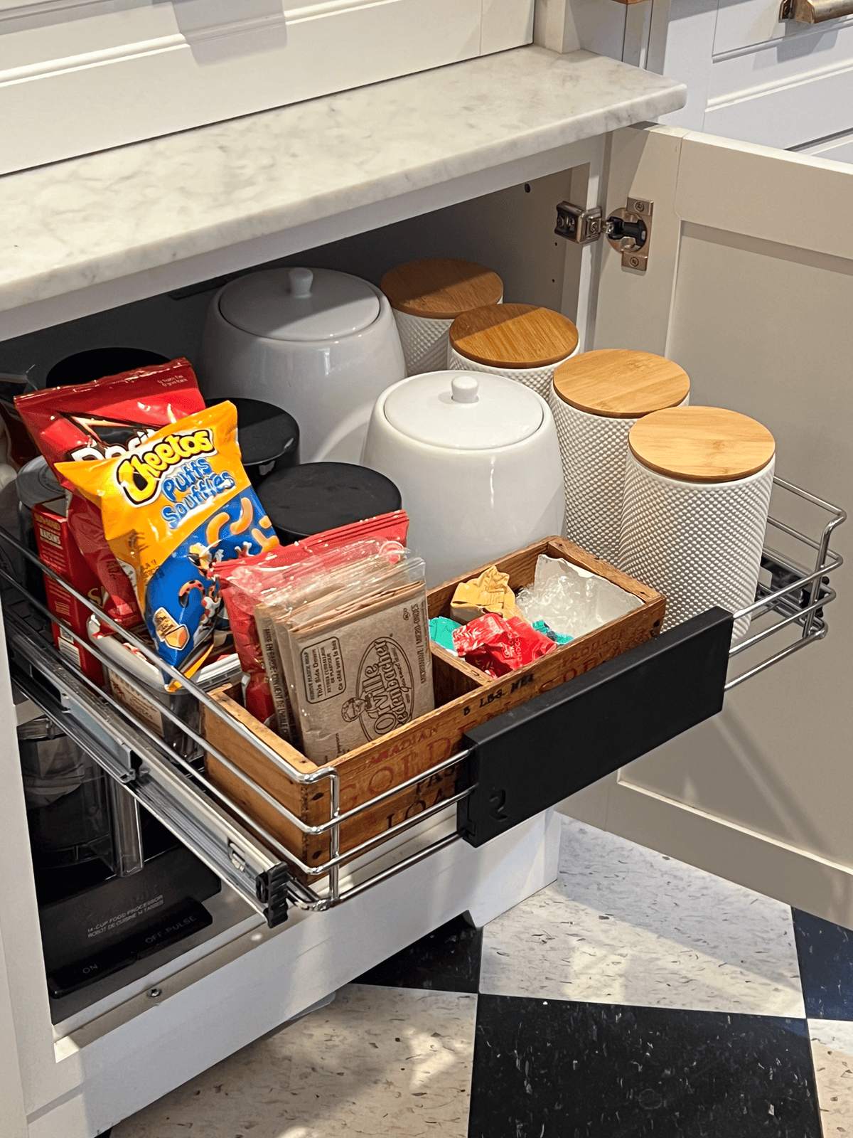 Pull out cabinet snack drawer with cheetos, popcorn, etc.