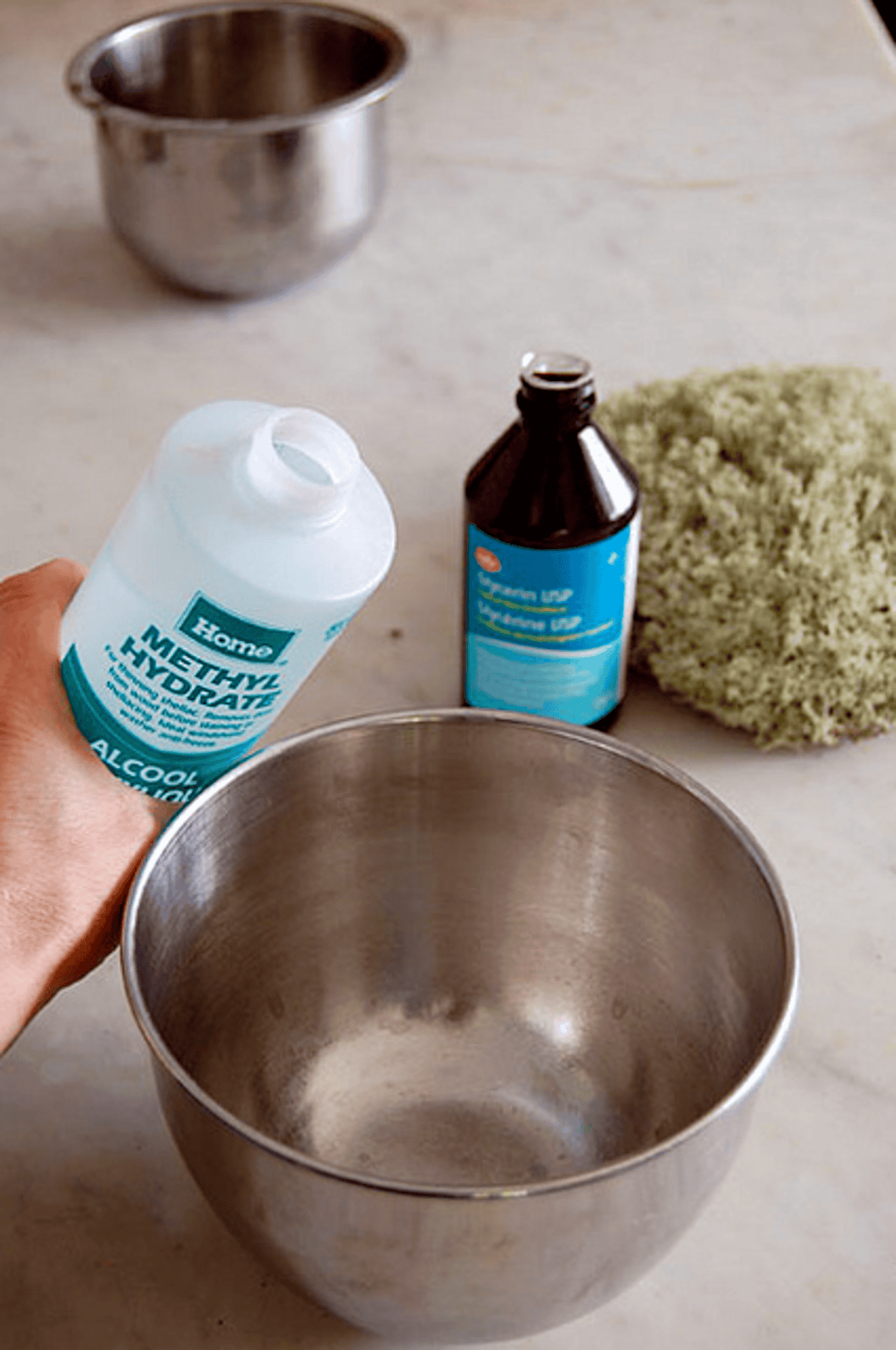 Methyl Hydrate being poured into stainless steel bowl with glycerin in the background.