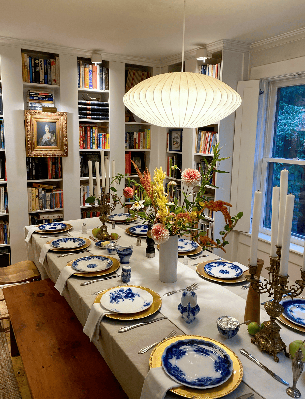 Harvest table set with linen, flowers and flow blue dishes.